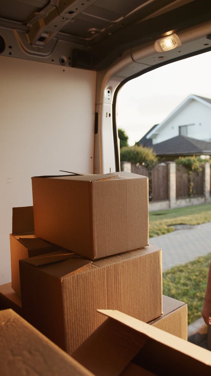 Mudanzas en Málaga. View inside a delivery van with stacked cardboard boxes ready for moving.
